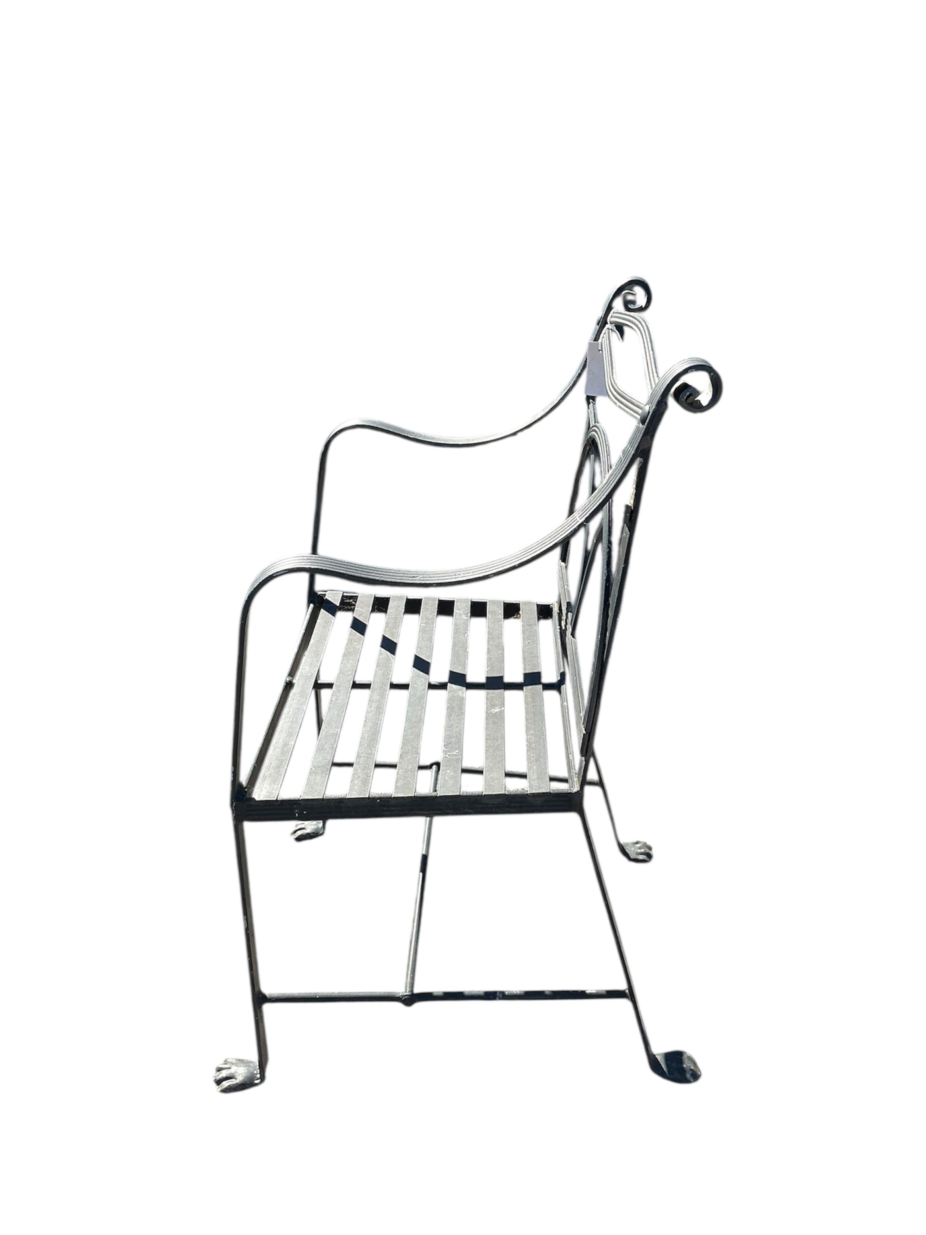 A set of four wrought iron garden chairs, width 53cm, depth 42cm, height 95cm